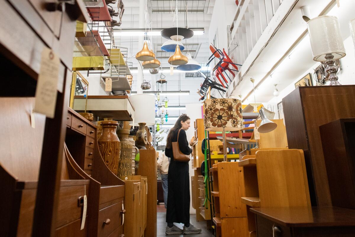 A woman shops for Midcentury Modern furnishings at Amsterdam Modern.