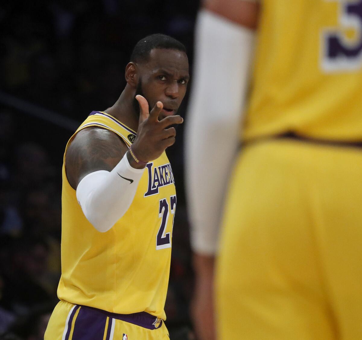 LeBron James communicates with Anthony Davis during the fourth quarter of the Lakers' loss to the Nets at Staples Center on March 10. 