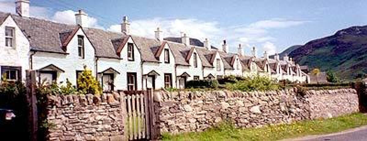 The row of identical cottages, built in the 19th century, is on Arran, a pretty, visitor-oriented island.