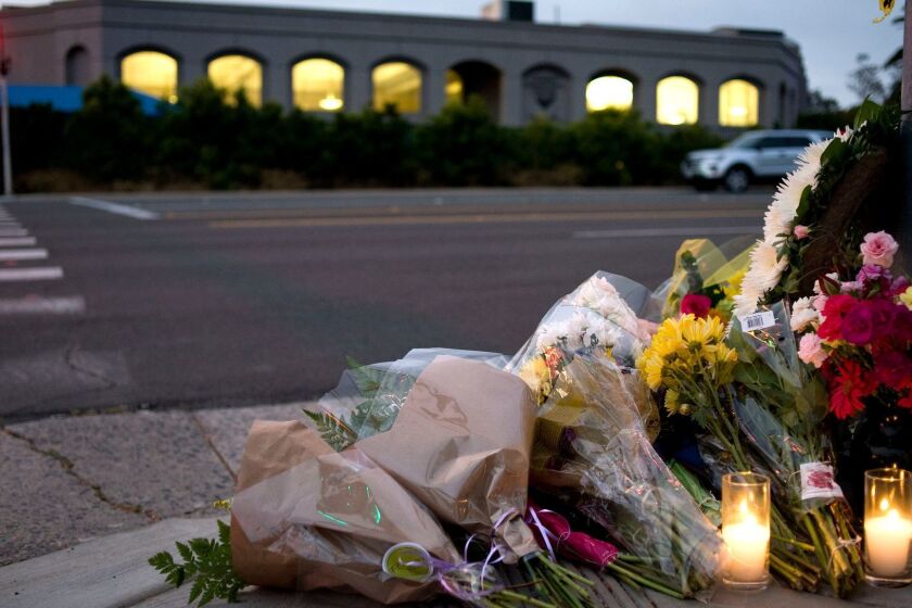 Mandatory Credit: Photo by DAVID MAUNG/EPA-EFE/REX (10221055b) Flowers and candles sit at a makeshift shrine across the road from the Chabad of Poway synagogue in Poway, California, USA, 27 April 2019 (issued 28 April 2019). An attack yesterday on the Chabad of Poway synagogue left one person dead and three injured. Poway synagogue shooting aftermath, USA - 27 Apr 2019 ** Usable by LA, CT and MoD ONLY **