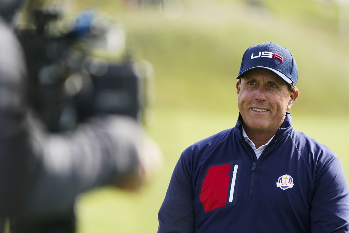 Phil Mickelson smiles during a practice day at the Ryder Cup at the Whistling Straits Golf Course Wednesday, Sept. 22, 2021, in Sheboygan, Wis. (AP Photo/Charlie Neibergall)