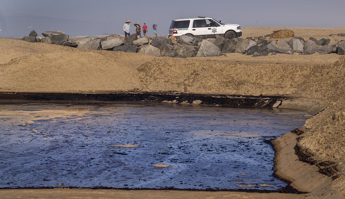 Four people at the Santa Ana River jetties