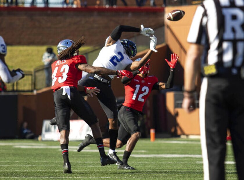 Western Kentucky defensive back Kahlef Hailassie (12) intercepts a pass to Middle Tennessee wide receiver Izaiah Gathings (2) during an NCAA college football game Saturday, Nov. 6, 2021, in Bowling Green, Ky. (Grace Ramey/Daily News via AP)