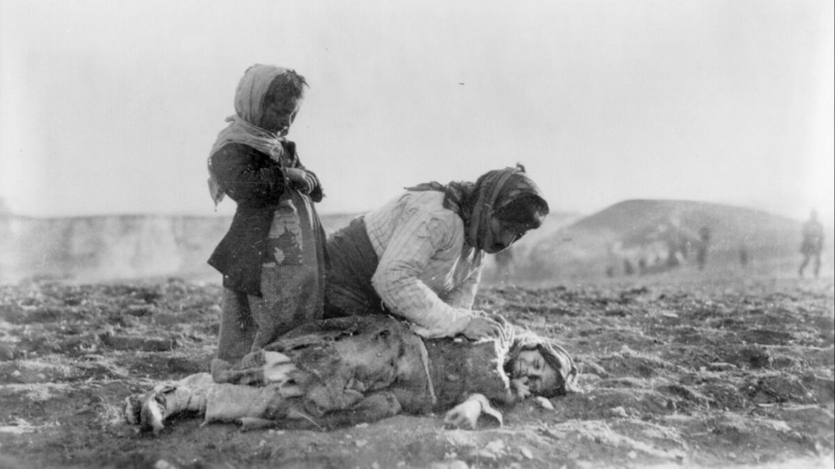 A young Armenian refugee lies dead in the fields within sight of Aleppo, Syria, in 1915.