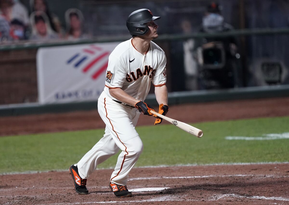 San Francisco Giants' Alex Dickerson watches his solo home run against the Colorado Rockies during the seventh inning of a baseball game on Monday, Sept. 21, 2020, in San Francisco. (AP Photo/Tony Avelar)