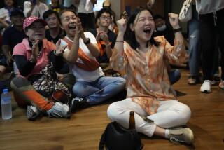 Supporters of Move Forward party cheer as they watch counting of votes on television at Move Forward Party headquarters in Bangkok, Thailand, Sunday, May 14, 2023. Vote counting was underway Sunday in Thailand's general election, touted as a pivotal chance for change nine years after incumbent Prime Minister Prayuth Chan-ocha first came to power in a 2014 coup. (AP Photo/Sakchai Lalit)