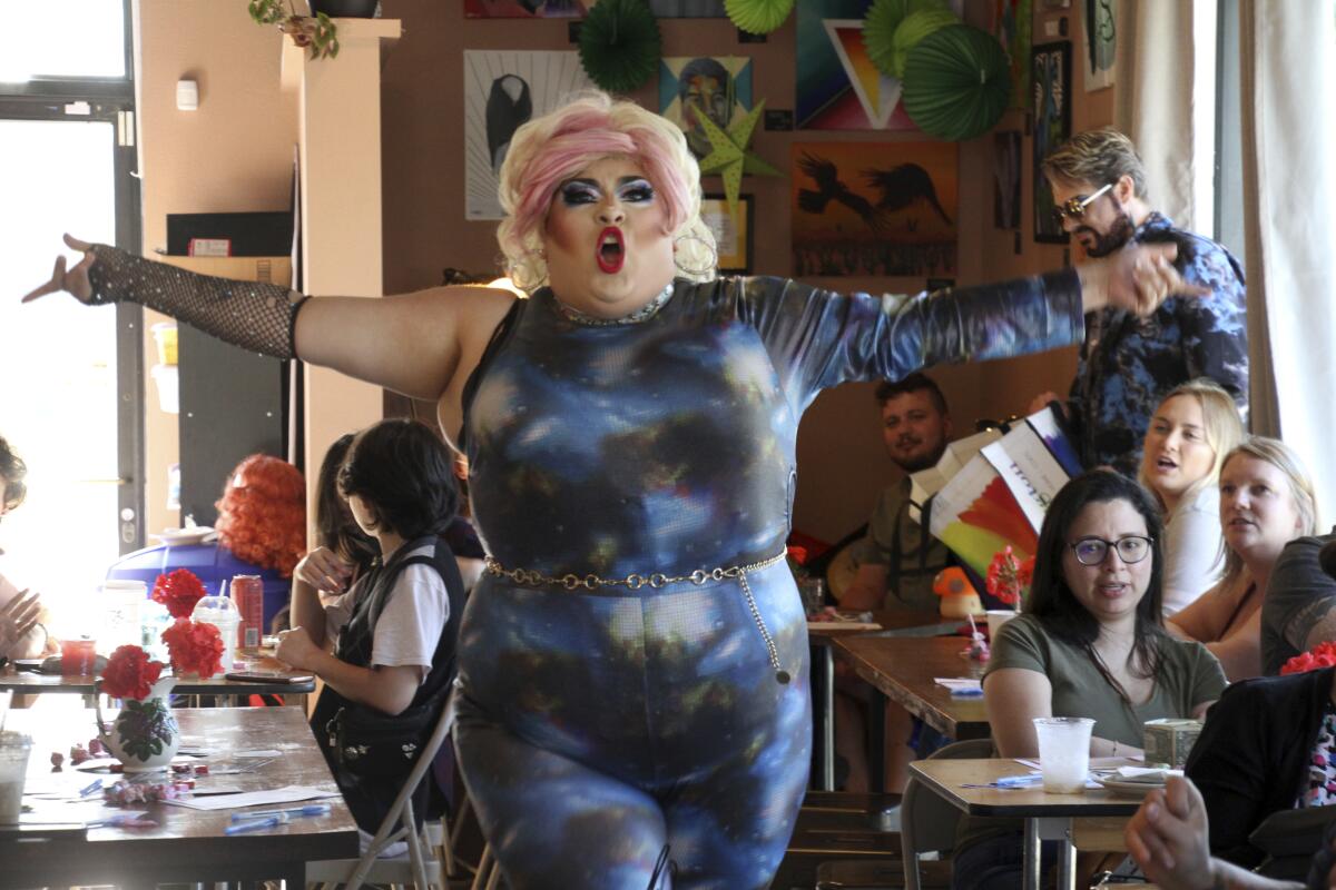 This July 28, 2022, photo shows drag queen Dela Rose performing in a mock election at Cafecito Bonito in Anchorage, Alaska where, people ranked the performances by drag performers. Several organizations are using different methods to teach Alaskans about ranked choice voting, which will be used in the upcoming special U.S. House election. (AP Photo/Mark Thiessen)
