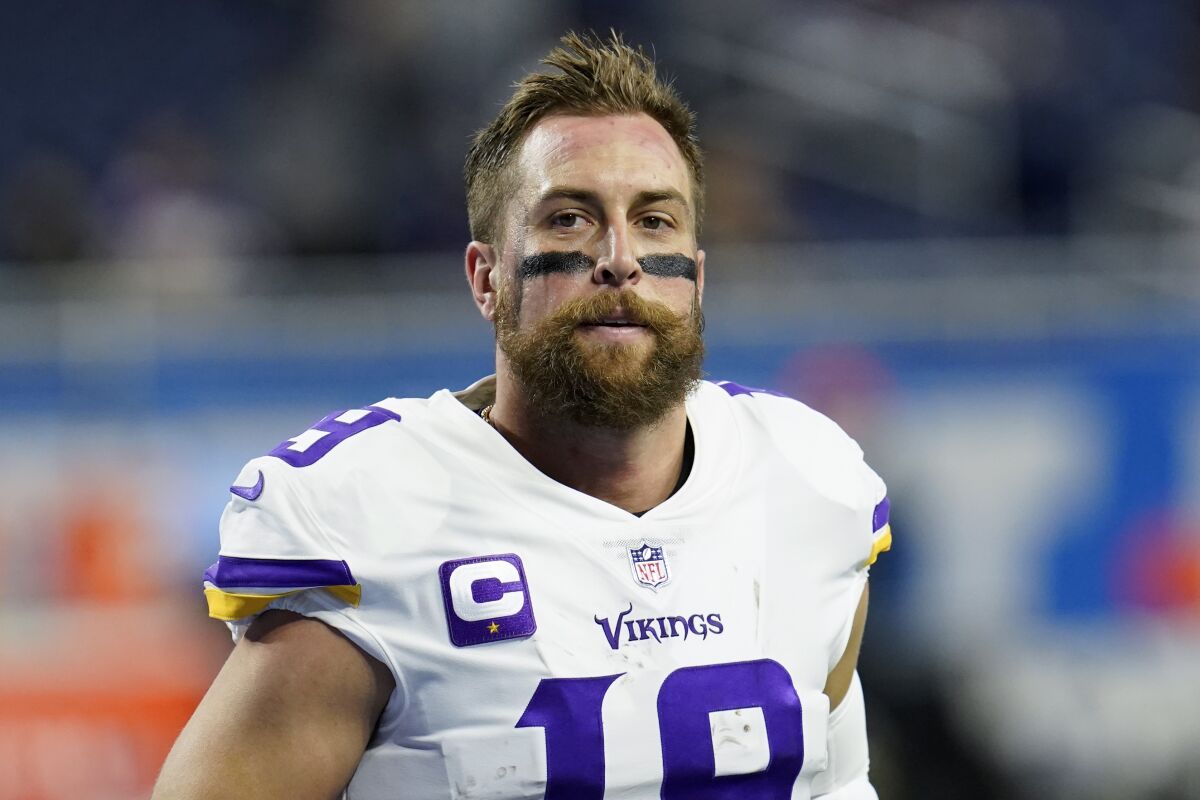 FILE - Minnesota Vikings wide receiver Adam Thielen runs before an NFL football game against the Detroit Lions in Detroit, Sunday, Dec. 5, 2021. Vikings wide receiver Adam Thielen has restructured his contract to give the team salary cap relief, his agency announced on Friday, March 18 2022, with a new deal that gives him $18 million guaranteed. (AP Photo/Paul Sancya, File)