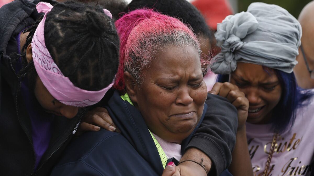 Samantha Mays, center, grieves with her son Ronnie and daughter Mollie at a news conference near where her 15-year-old daughter Hannah was fatally shot last week.