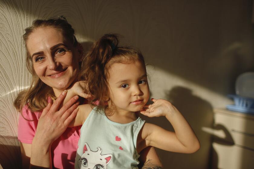 NOVOSIBIRSK, RUSSIA. FEBRUARY 26, 2020 - Svetlana Sumina, 38, and her daughter. Uliyana, 3, in their rented apartment in Novosibirsk, Russia. Sumina was diagnosed with HIV in 2008. Sumina started taking the drugs in 2016 when she became pregnant in 2016 and gave birth to a healthy girl, Uliyana.(Valeriy Klamm / For The Times)