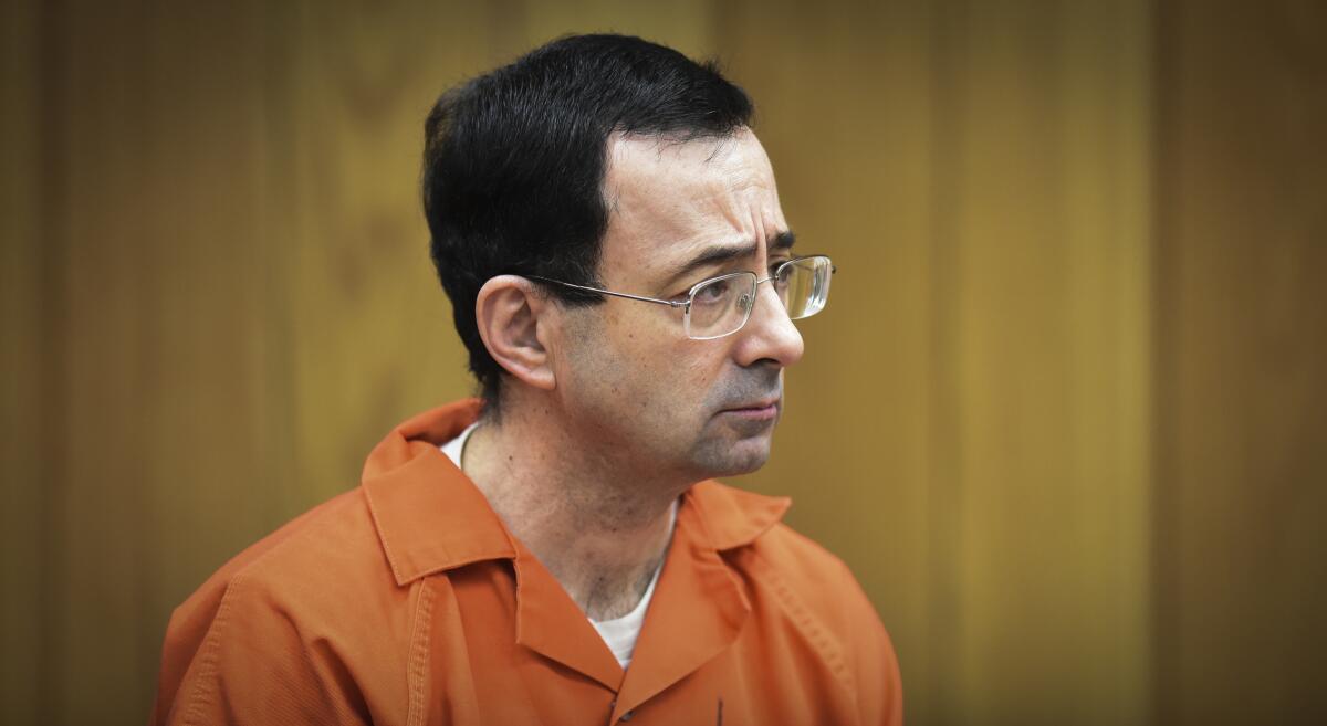 Larry Nassar appears in court in an orange jumpsuit.