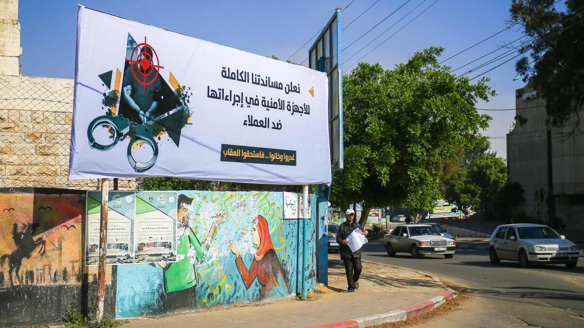 A banner in Gaza City on Wednesday reads: "We declare our full support for the security authorities in their measures against collaborators" and "they betrayed and backstabbed and deserved the punishment."