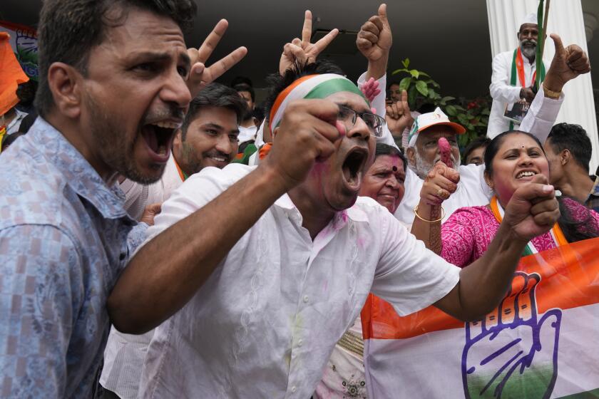Supporters of opposition Congress party celebrate early leads for the party in the Karnataka state elections in Bengaluru, India, Saturday, May 13, 2023. Elections in India's southern state of Karnataka were held on May 10. (AP Photo/Aijaz Rahi)