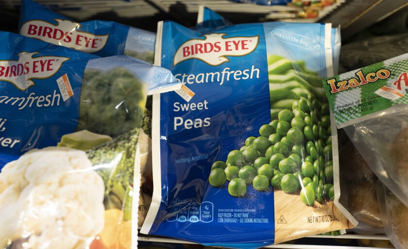 FILE - A bag of Birds Eye sweet peas is displayed Thursday, March 25, 2021, in a New York supermarket. Inflation is pressuring ConAgra Brands' performance and the food company is lowering its fiscal full-year adjusted earnings outlook as it contends with higher-than-anticipated cost pressures. ConAgra, whose brands include Birds Eye, Slim Jim and Reddi-wip, also said Thursday, April 7, 2022, that it will need to make additional price increases to deal with the current environment. (AP Photo/Mark Lennihan)