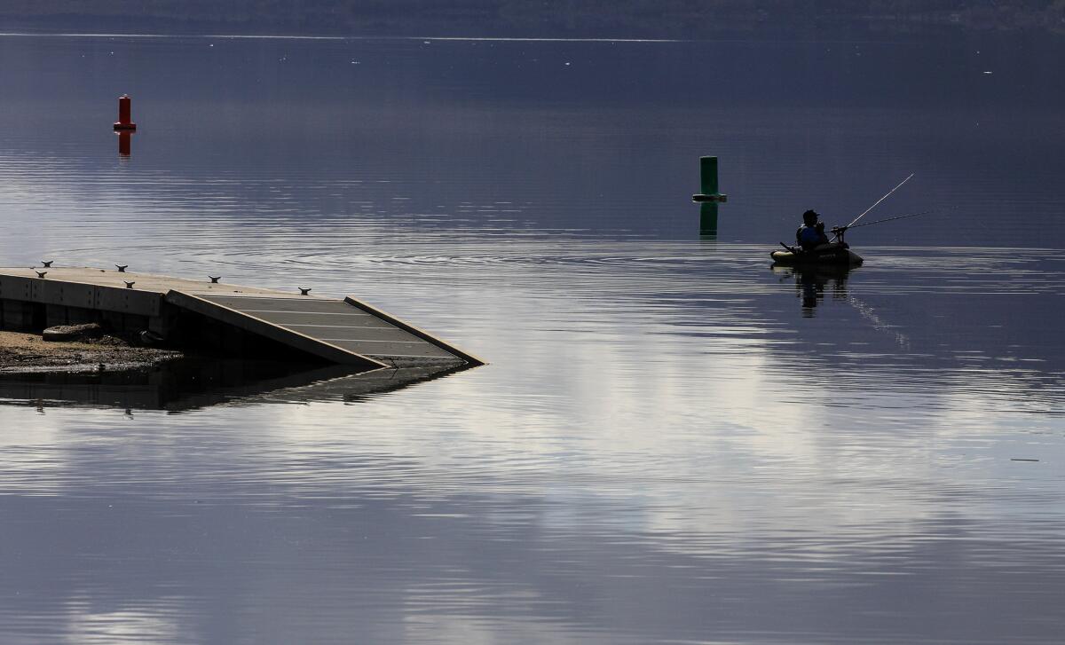 Float Fisherman Johnathan O. Skinner casts his line near one of the submerged docks at Launch Pointe on Lake Elsinore. 