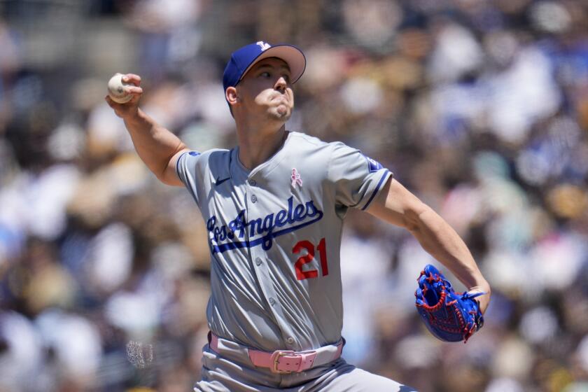 Dodgers starting pitcher Walker Buehler delivers a throw from the mound during a game against the Padres 