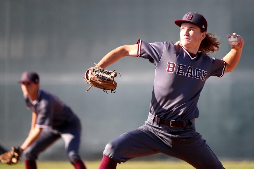Laguna Beach High baseball pitcher Aidan Kidd throws in away game vs. Edison High, at the Chargers home field in Huntington Beach on Friday, March 6, 2020.