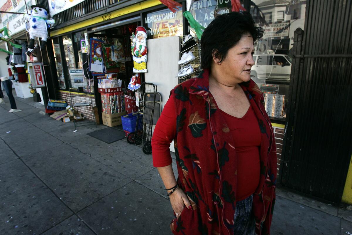 Bertha Cuestas stands on the sidewalk outside a Monte Vista Street market in Highland Park one block from her apartment.