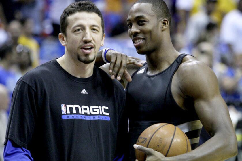 In 2009, Orlando teammates Hedo Turkoglu and Dwight Howard talk before a game against the Lakers in the NBA Finals.