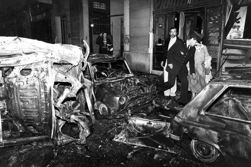 FILE - A police officer walks at the scene after the bombing of the Copernic street synagogue, in Paris, that killed 4 people on This Oct. 3, 1980. A Lebanese-Canadian academic and lone suspect in a 1980 bombing outside a Paris synagogue will go on trial Monday April 3, 2023, nearly 43 years after four people were killed and dozens wounded in the unclaimed attack. (AP Photo/Remy de la Mauviniere, File)