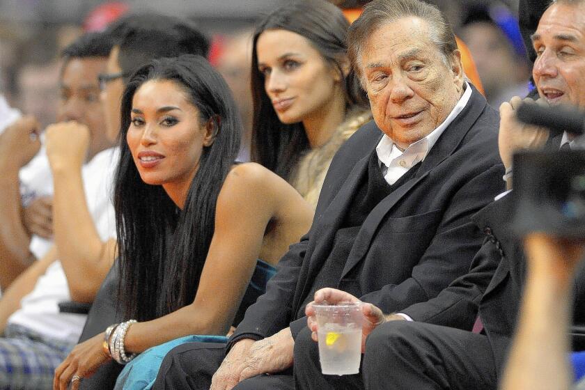 V. Stiviano, left, watches the Clippers with owner Donald Sterling in October. Stiviano is being sued by Sterling's wife, who alleges the 31-year-old was in a romantic relationship with her husband, 80.