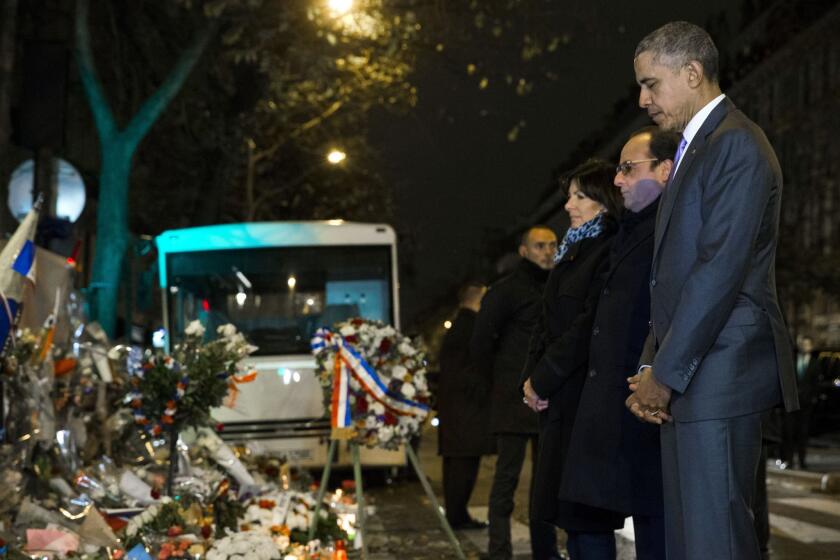 President Obama, French President Francois Hollande and Paris Mayor Anne Hidalgo pause for a moment of silence at the Bataclan, site of one of the Paris terrorists attacks.