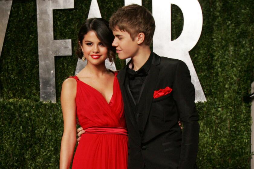 Selena Gomez and Justin Bieber, shown at the 2011 Vanity Fair Oscar party where they first delivered PDA, are rekindling their flame.