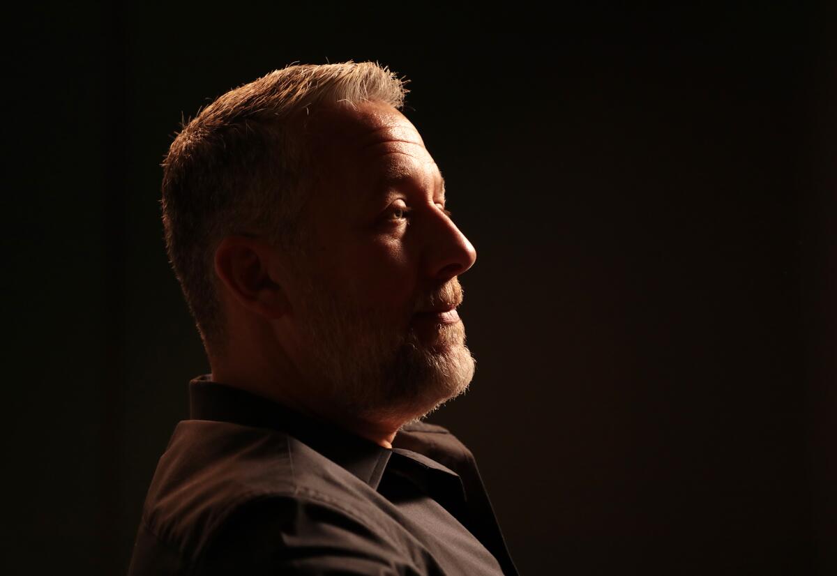 Profile view of a man in front of a black background