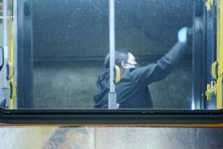 A crime scene investigator dust for fingerprints on a Metro bus after a man died Thursday night, Feb. 22, 2024.