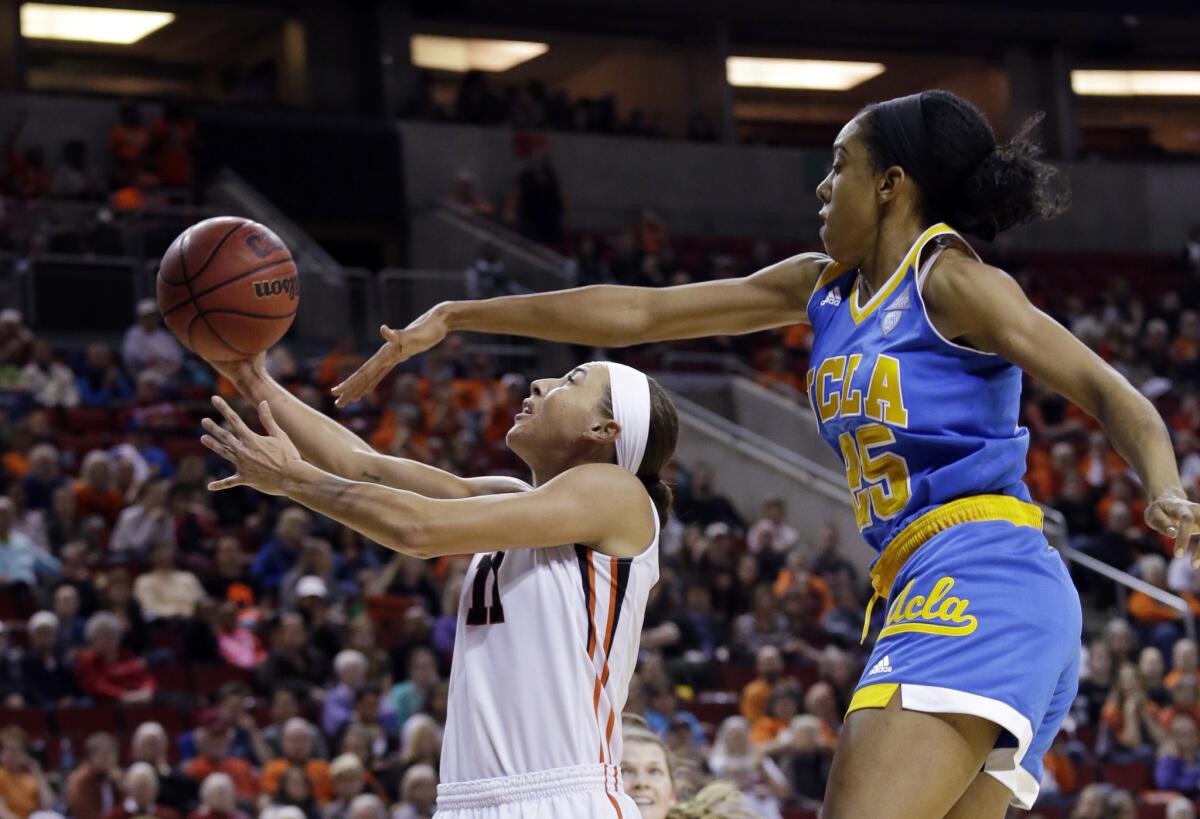 Oregon State's Gabriella Hanson (11) shoots as UCLA's Monique Billings defends in the first half of the Pac-12 tournament championship.