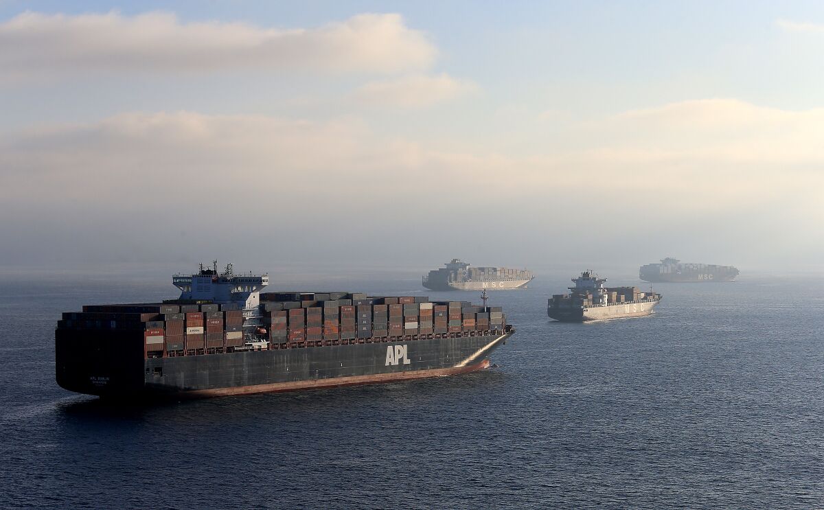 Cargo ships are in the ocean. 