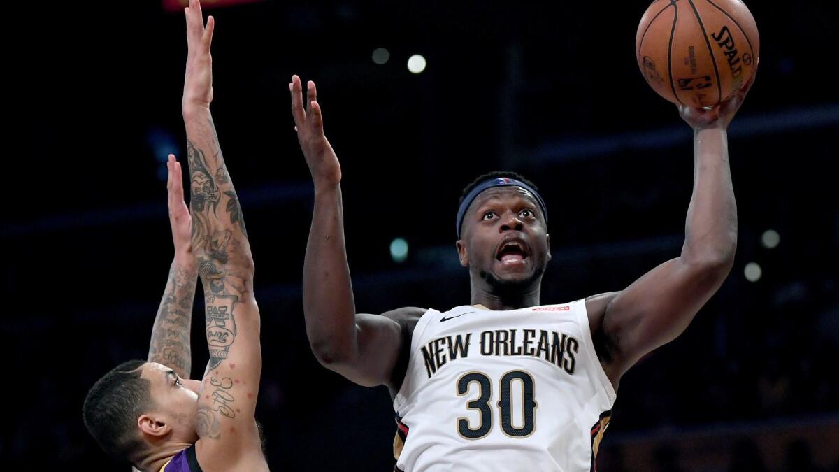 Julius Randle of the New Orleans Pelicans scores in front of Kyle Kuzma of the Lakers during the first half Friday.