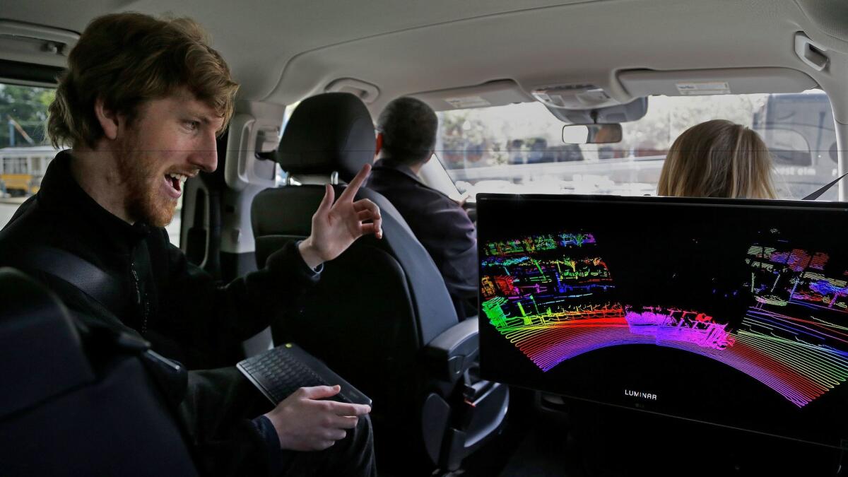 Luminar Technologies Chief Executive Austin Russell looks at a 3-D lidar map on a demonstration drive in San Francisco.