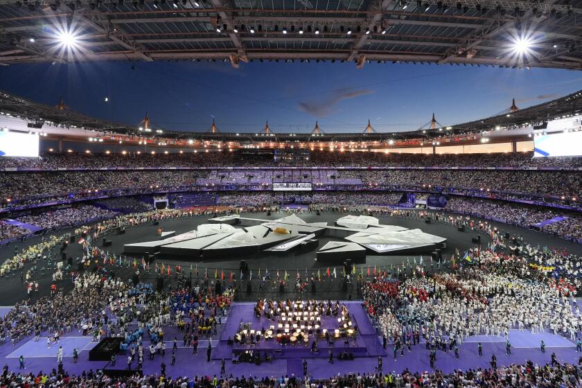 Athletes fill the infield during the 2024 Summer Olympics closing ceremony at the Stade de France, Sunday, Aug. 11, 2024, in Saint-Denis, France. (AP Photo/Rebecca Blackwell)