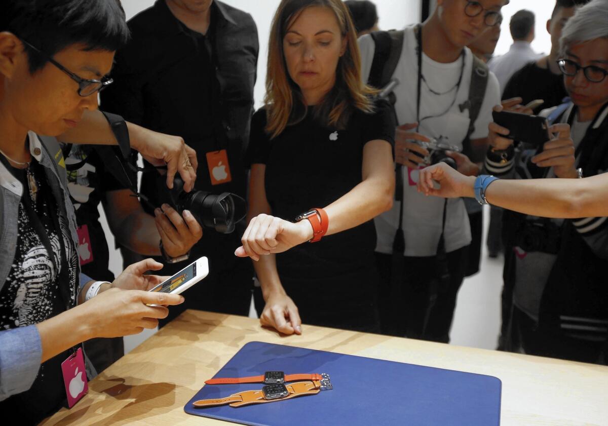 People try out new Apple Watch bands after the company's announcement of new products during an event at the Bill Graham Civic Auditorium in San Francisco.