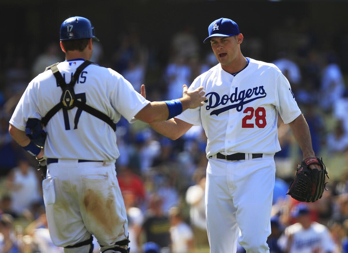 Jamey Wright (28), then a Dodgers closer, shakes hands with catcher A.J. Ellis after a win over St. Louis on June 29, 2014.