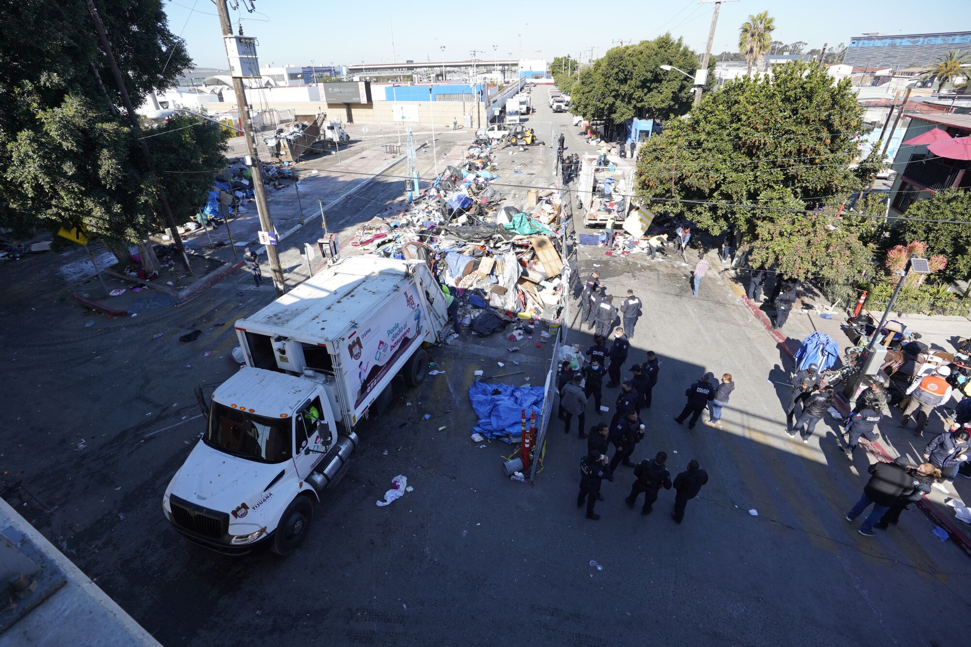 A high-angle photograph of authorities clearing an encampment