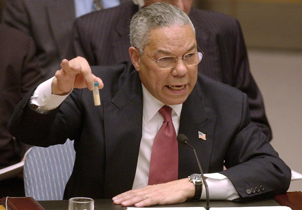 Then-Secretary of State Colin Powell holds up a vial in 2003.