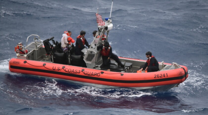 The Coast Guard Cutter Thetis’ crewmembers deploy the cutter’s small boat to rescue people in the water approximately 32 miles southeast of Key West, Fla., on Tuesday, July 6, 2021. The U.S. Coast Guard and a good Samaritan rescued 13 people after their boat capsized off of Key West as Tropical Storm Elsa approached. (U.S. Coast Guard via AP)