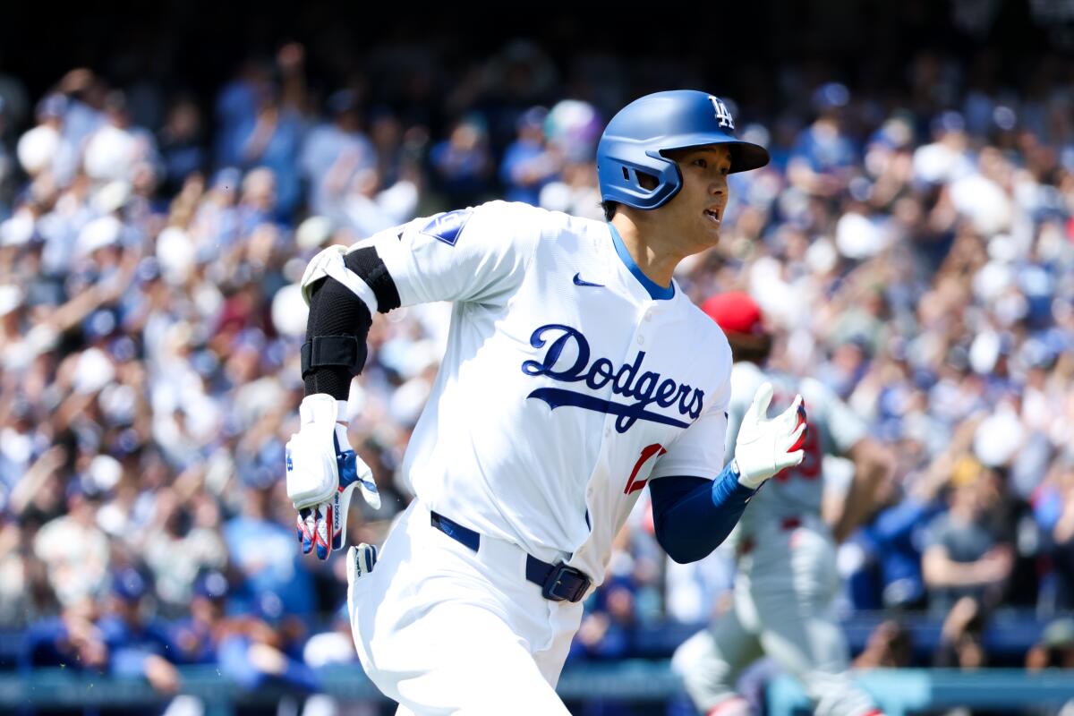 Dodgers designated hitter Shohei Ohtani runs to first base after hitting a double against the St. Louis Cardinals.