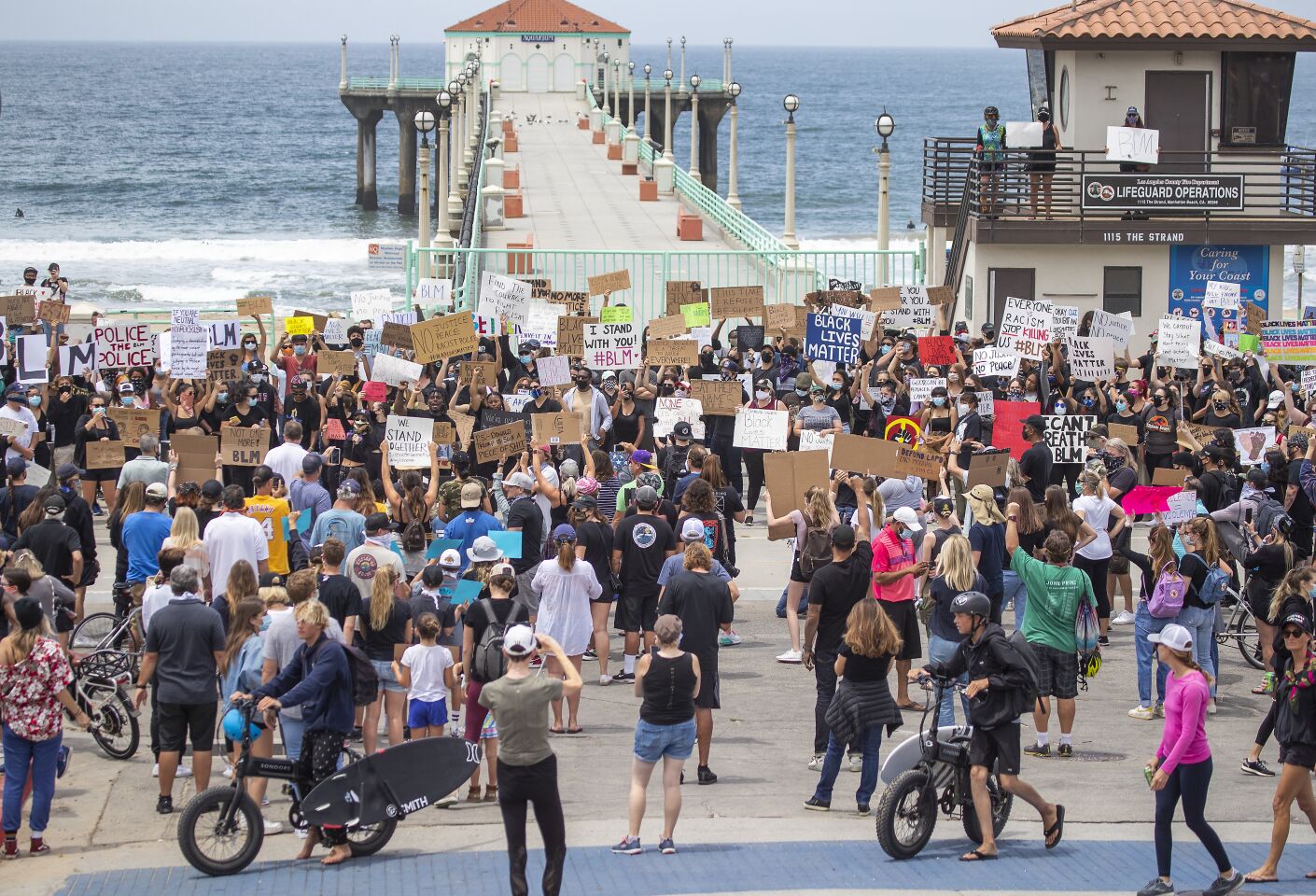 Several hundred protesters gather to demand justice for George Floyd at the Manhattan Beach Pier Plaza