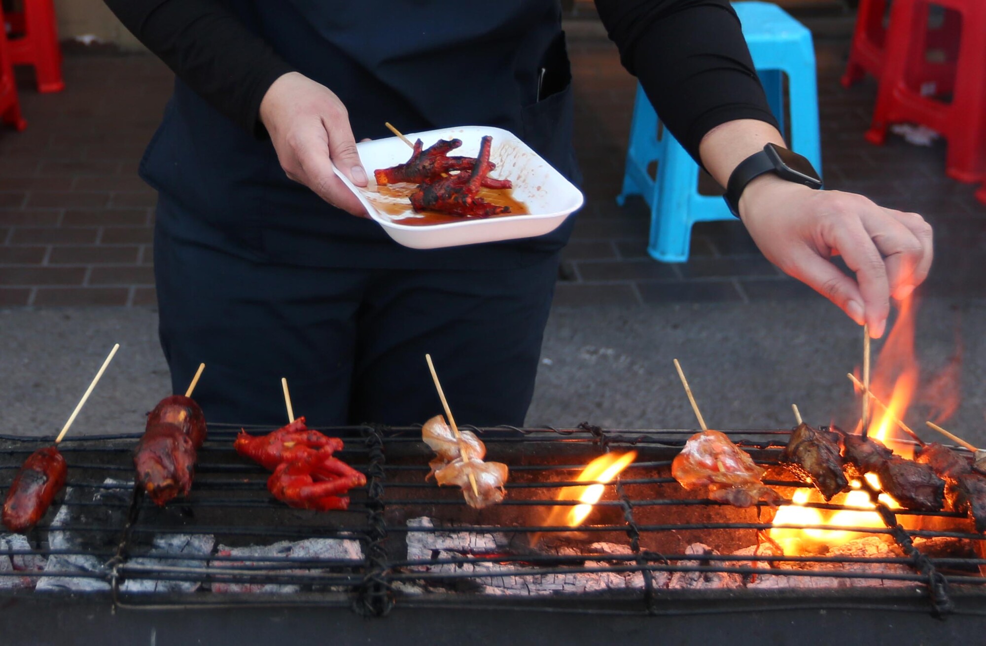 Meat skewers are grilled at a restaurant in Historic Filipinotown.