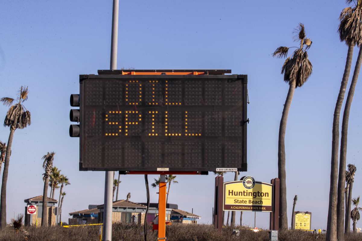A road sign reads, "OIL SPILL" 