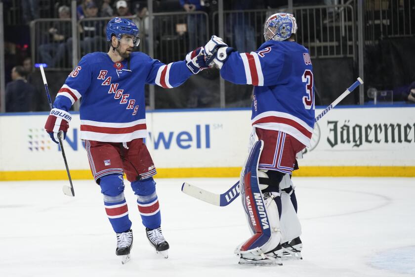 New York Rangers goaltender Jonathan Quick, right, celebrates with Erik Gustafsson, left, after an NHL hockey game against the New Jersey Devils, Monday, March 11, 2024, in New York. (AP Photo/Seth Wenig)