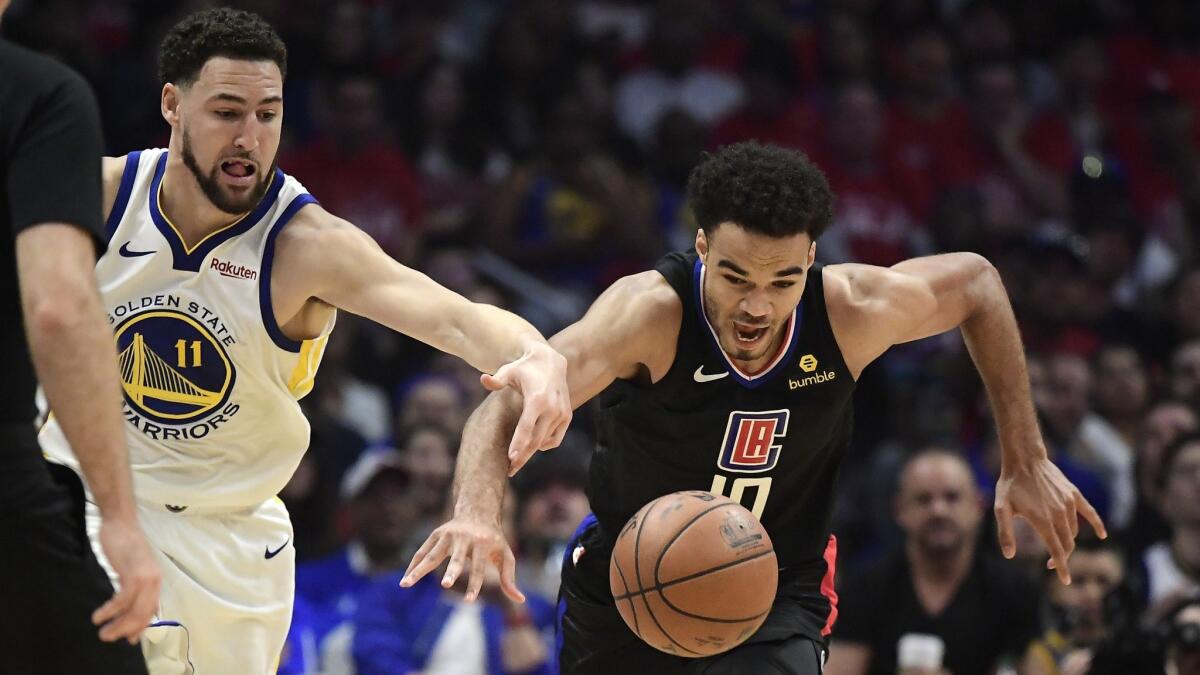 Golden State Warriors guard Klay Thompson, left, and Los Angeles Clippers guard Jerome Robinson reach for a loose ball during Game 4 of the Western Conference quarterfinals on April 21. Robinson will be taking part in summer league play.