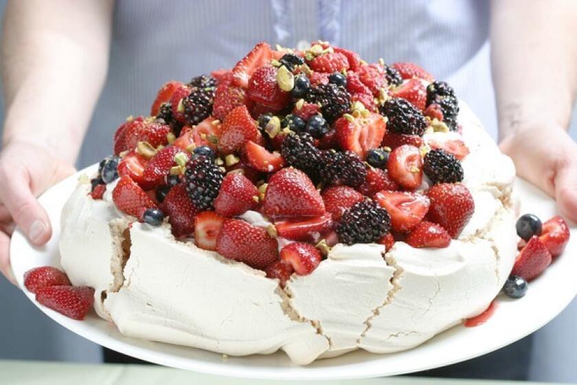 Dive on in. Recipe: Berry Pavlova with vanilla whipped cream and pistachios