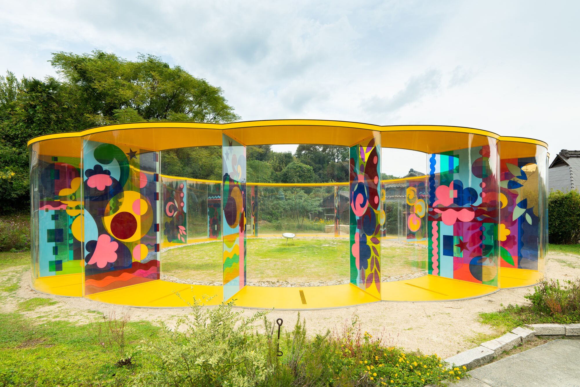 A circular outdoor installation with brightly painted panels.
