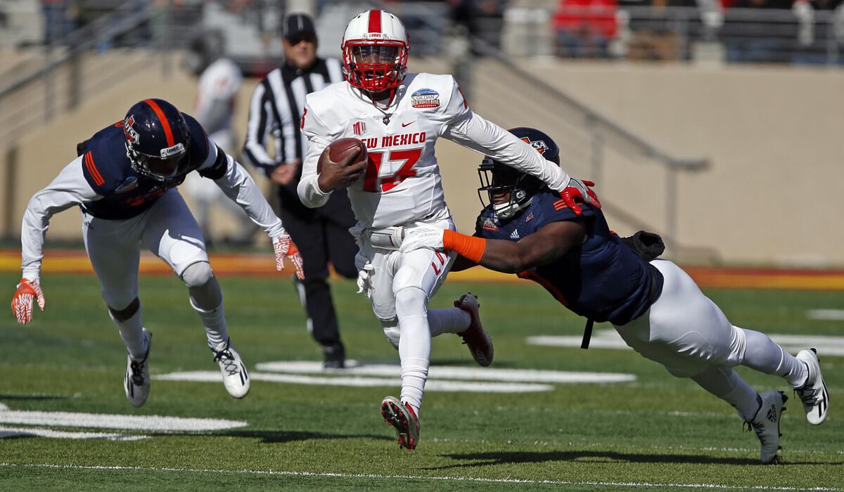New Mexico quarterback Lamar Jordan, center, is sacked by UTSA safety Michael Egwuagu during the first half of the New Mexico Bowl on Saturday.