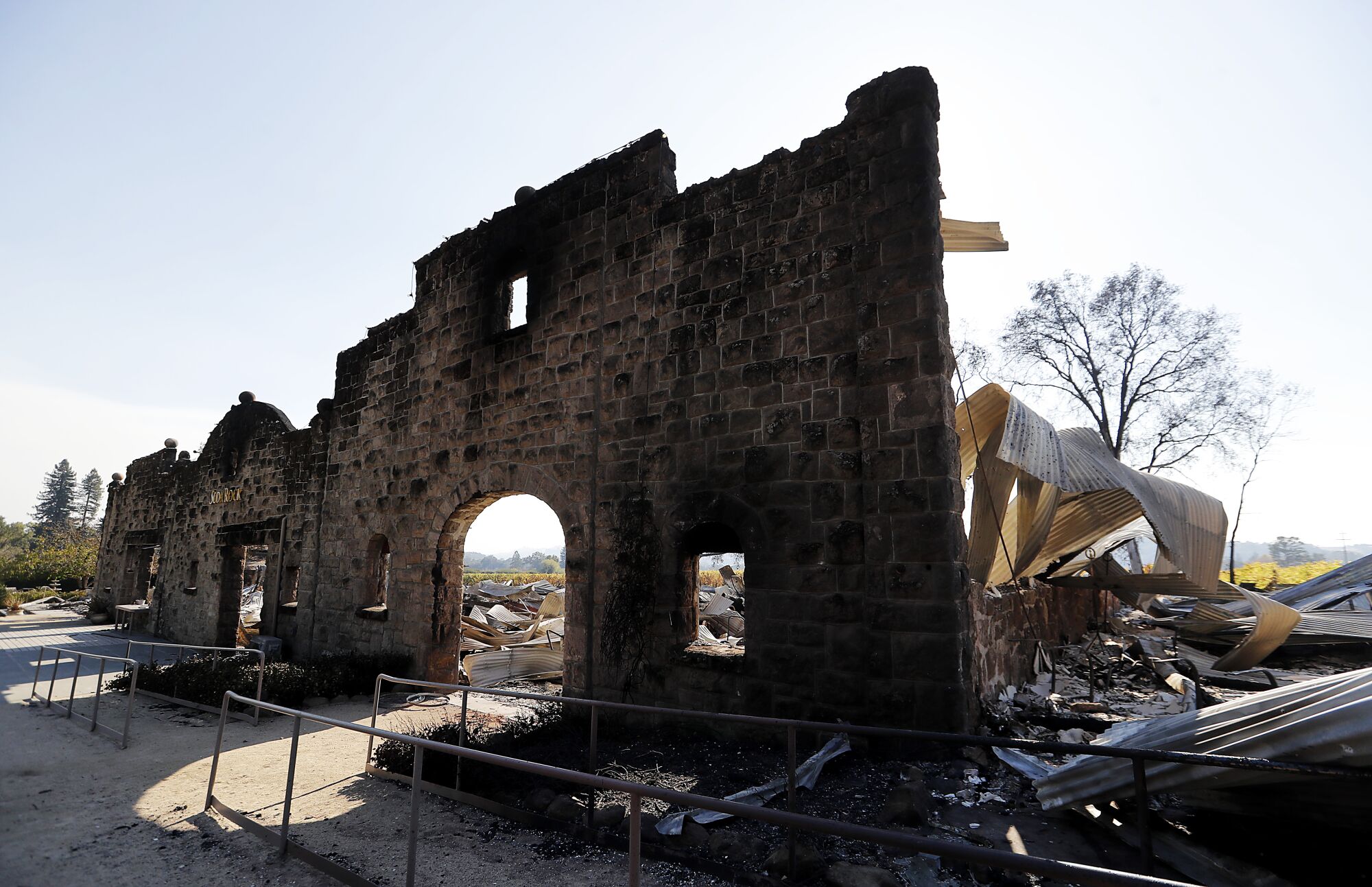 A stone facade is all that remains standing at the Soda Rock Winery, which was destroyed by the Kincade fire.