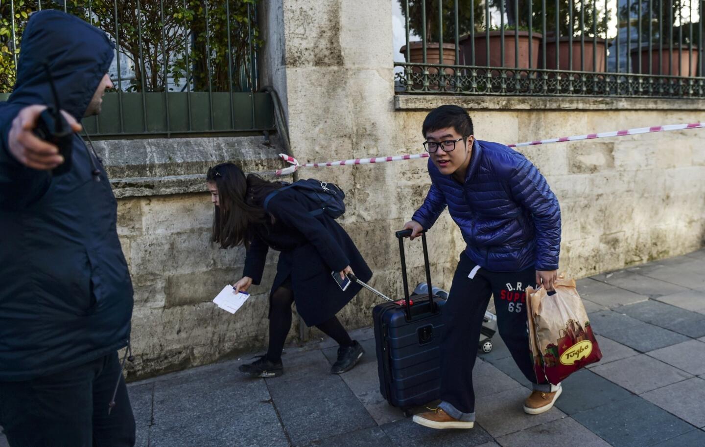 Tourists leave the area near a blast in Istanbul's tourist hub of Sultanahmet on Jan. 12, 2016.